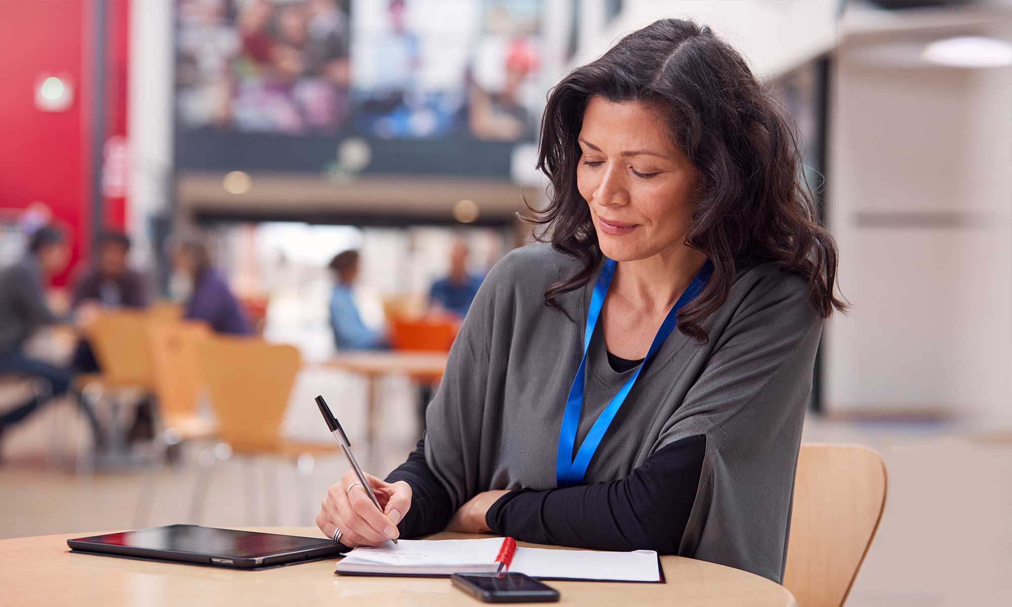 teacher-with-ipad-and-notebook